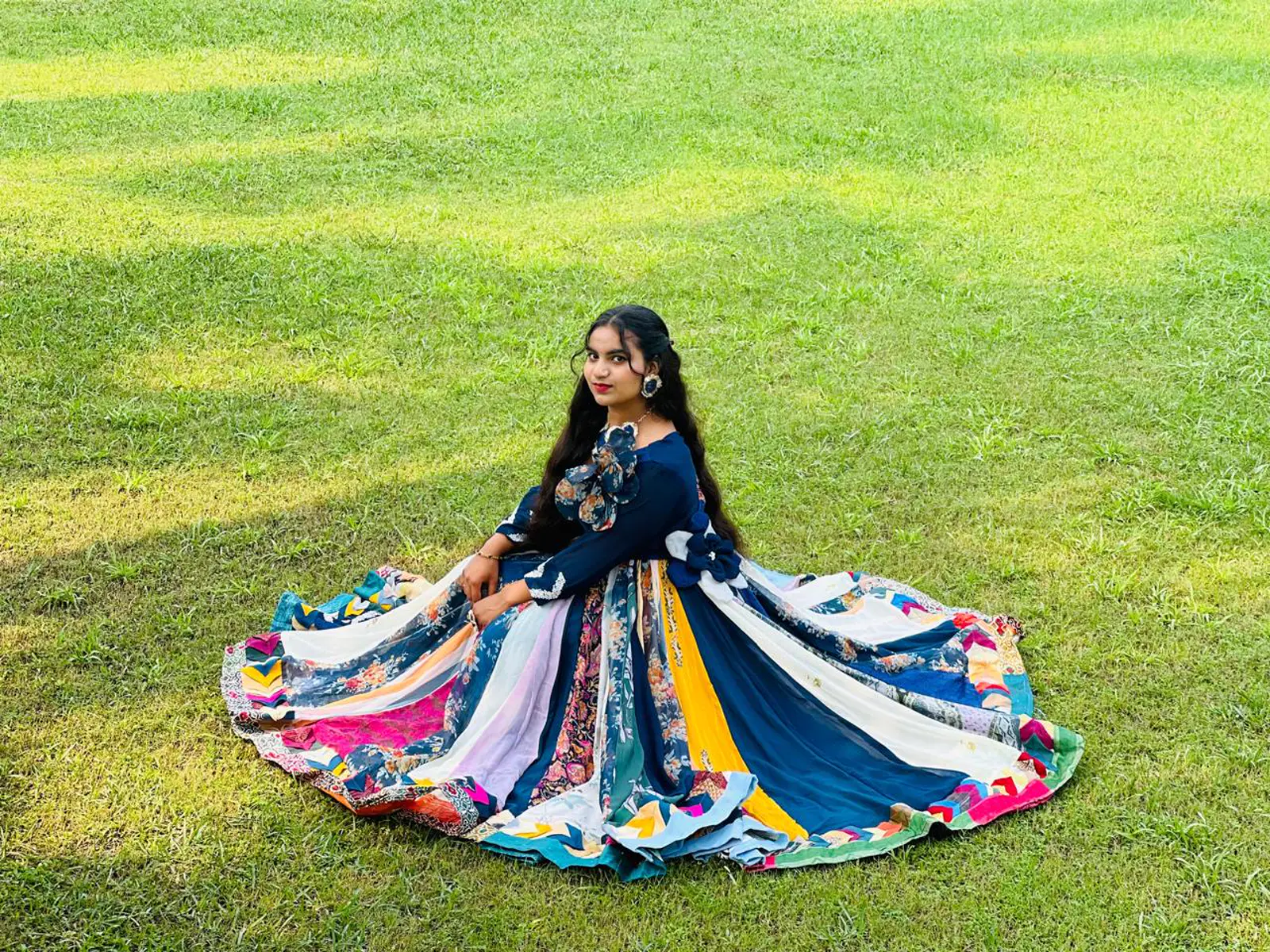 BRD student showcasing a dress created from household scrap materials